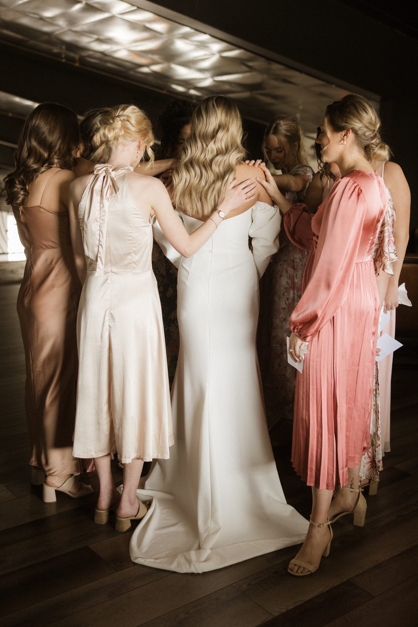 Bride hugging her bridesmaids