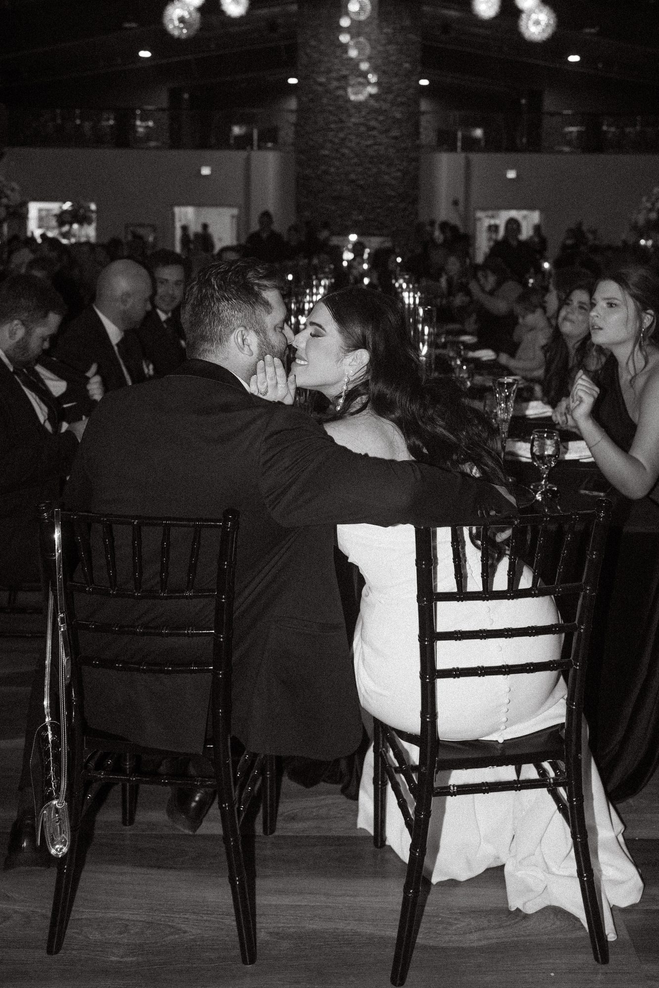 Guests seated at candlelit reception tables